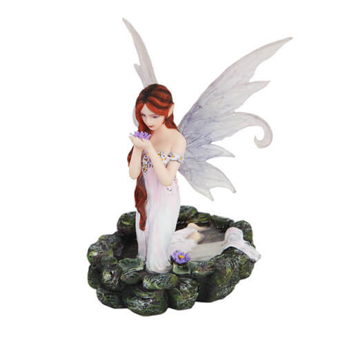 Fairy figurine - redhaired pixie kneeling in a pond holding a purple water lily with another next to her