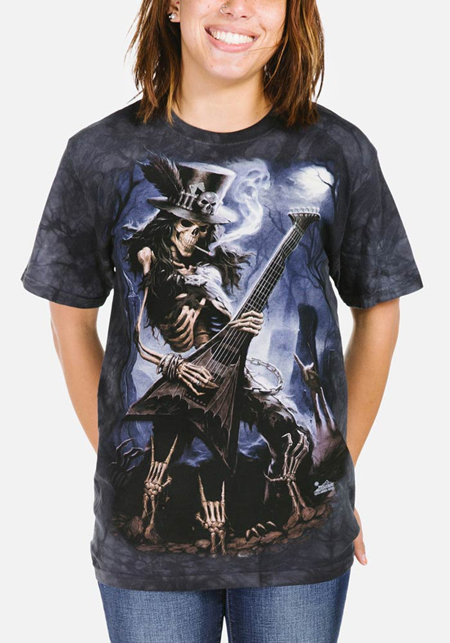 Lady wearing shirt with skeleton playing guitar