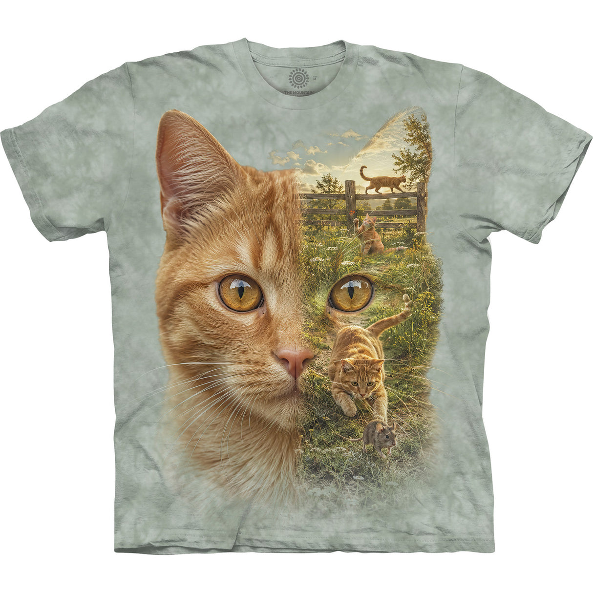 A short-sleeve crewneck t-shirt in a light sage green tie-dye pattern, featuring a large graphic print of an orange tabby cat's face on the front, with its eye area showing a scenic outdoor landscape of cats running on grass.
