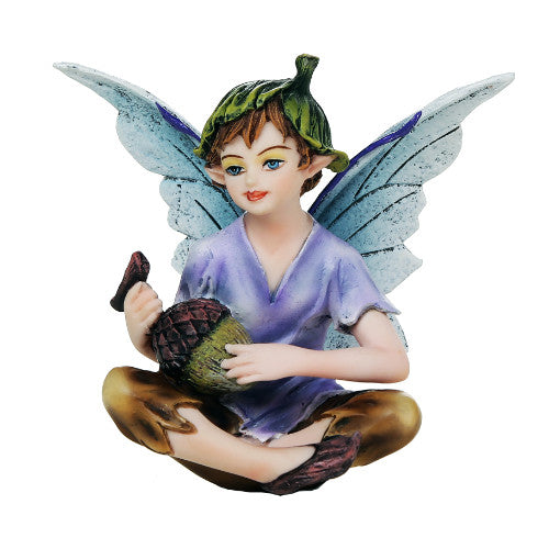 Figurine of a fairy boy with blue wings, purple shirt, brown pants, green flower bud hat sitting crosslegged with an acorn in his lap