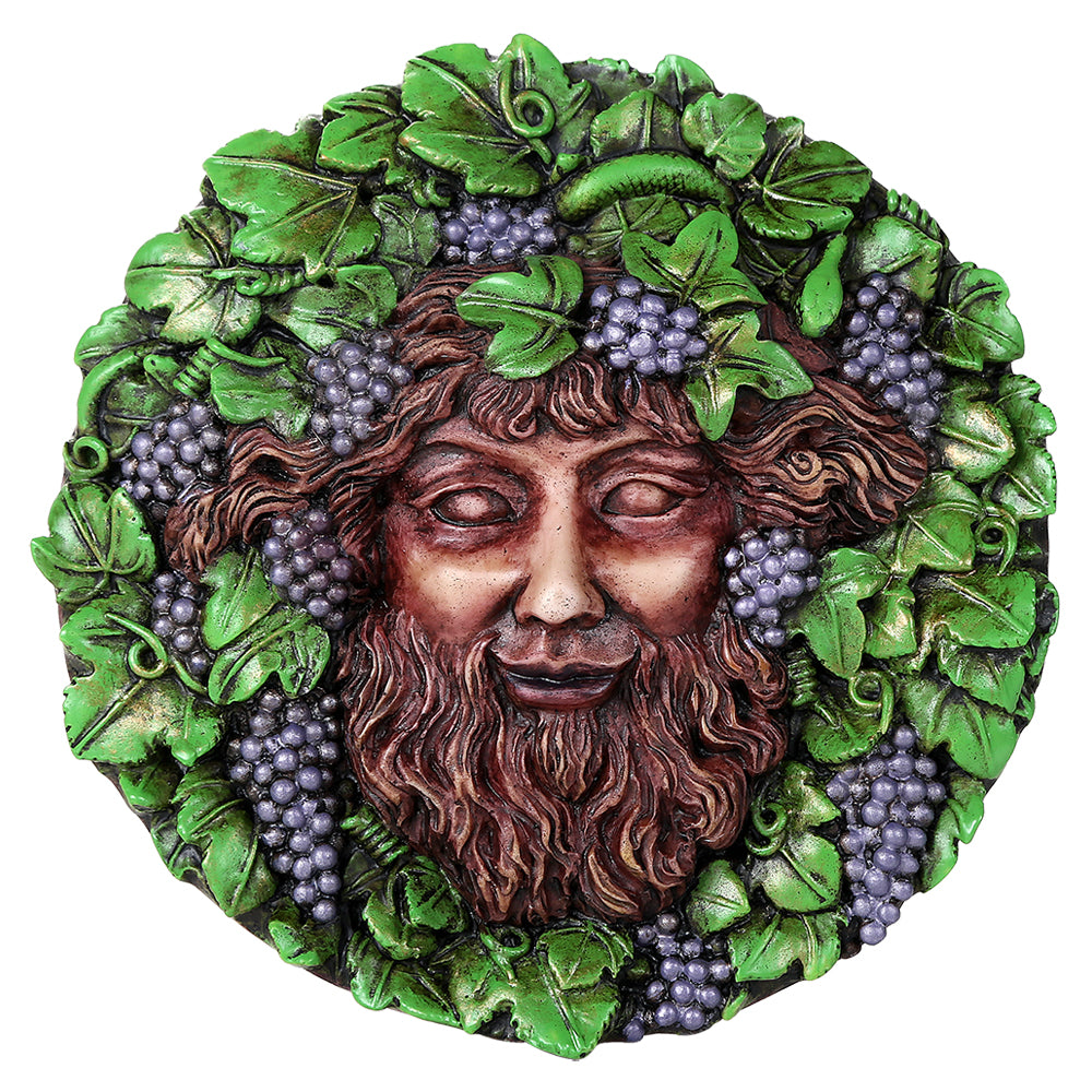 Round decorative wall plaque featuring a classical male face - the god Bacchus - surrounded by green leaves and clusters of purple grapes