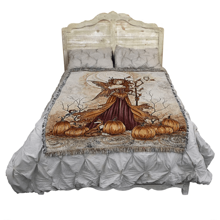 Pumpkin Queen tapestry blanket shown on a bed