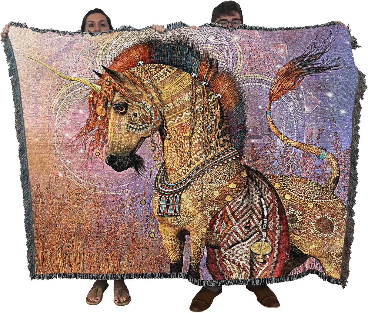 Decorative blanket with a tribal unicorn design featuring intricate patterns and colors by Laurie Prindle, held up by two adults to show large size