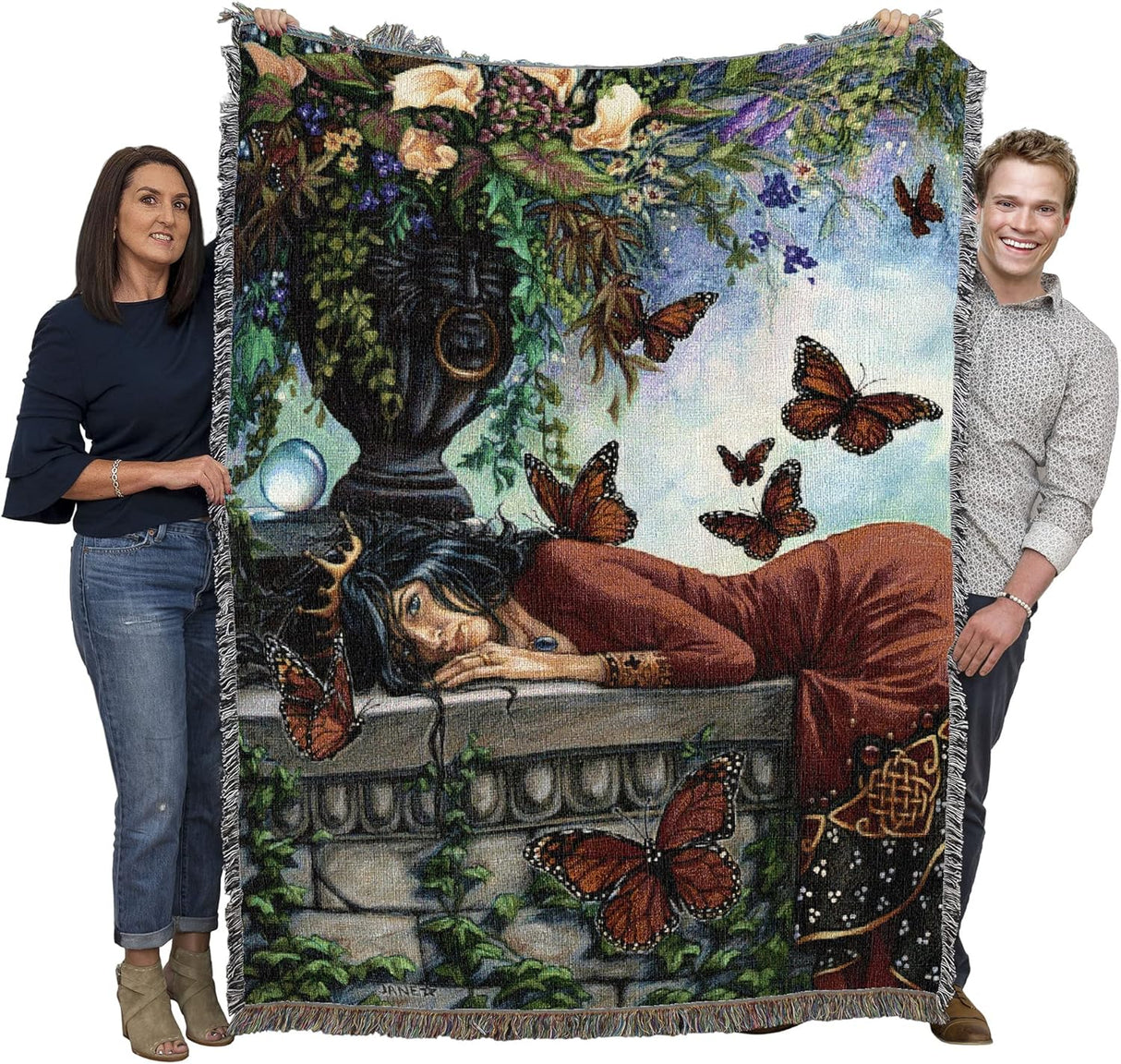 Monarch butterfly queen tapestry blanket held up by two adults to show the large size