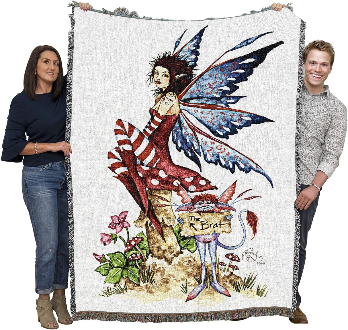 Tapestry blanket by Amy Brown, fairy in red on mushroom with gnome holding sign that says "The Brat", shown held by adults, large size