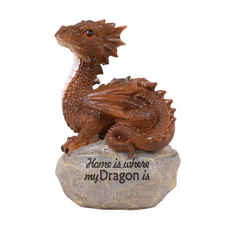 Figurine of a brown dragon sitting on a rock, carved into the stone is "Home is where my Dragon is"