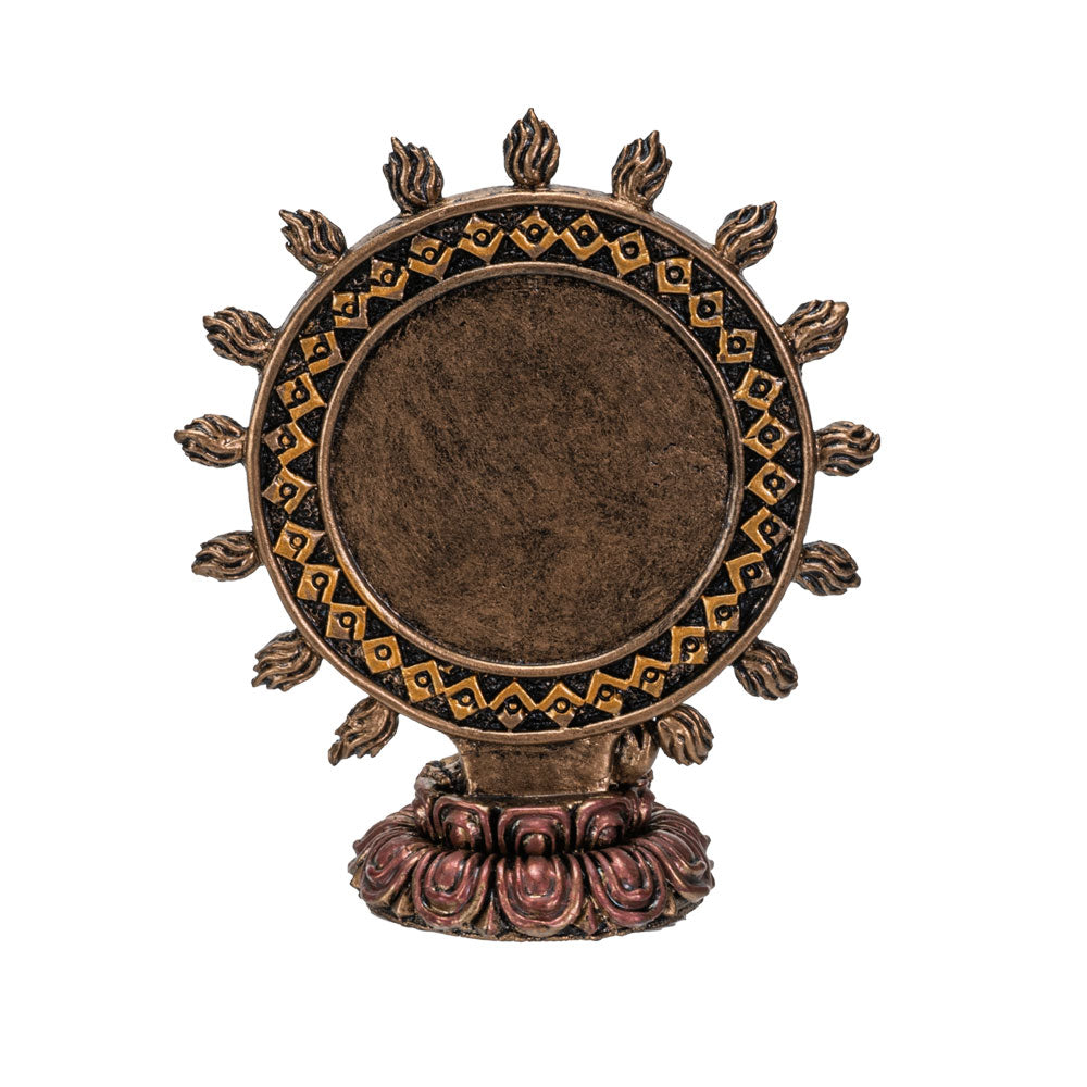Decorative bronze wheel with intricate designs on a white background