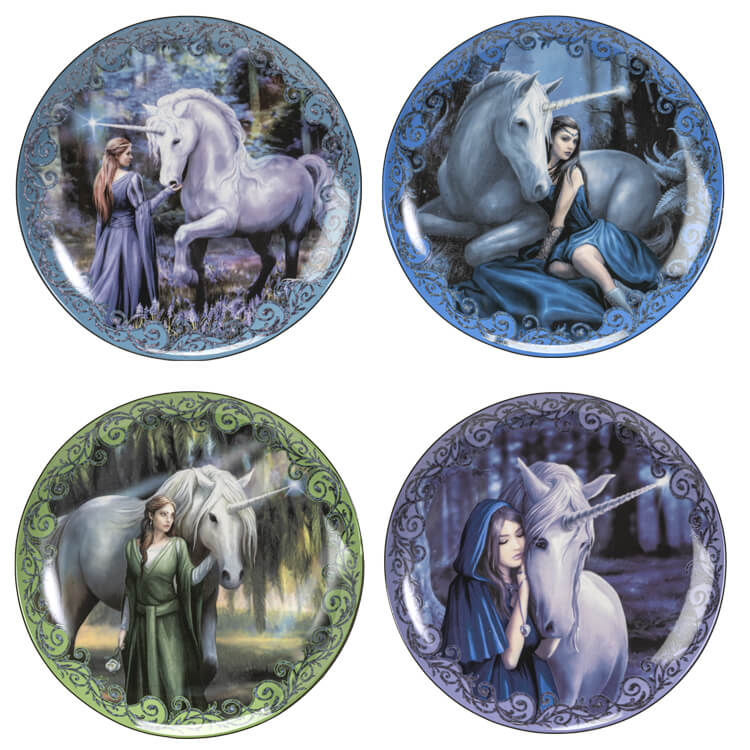 Set of 4 porcelain dessert plates showing Anne Stokes artwork. Unicorn and woman standing in flowers at the edge of the forest, unicorn and woman in blue laying down, woman in green with white unicorn, and cloaked woman with unicorn