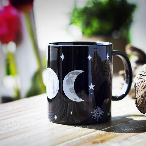 Black ceramic mug with white triple moon and star designs