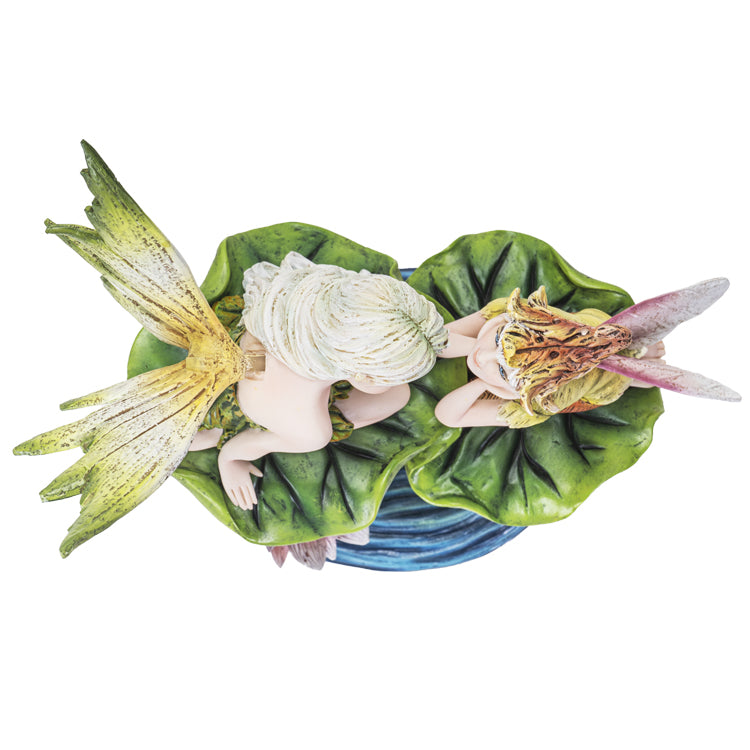 This figurine has a fairy sitting with an elf. The fairy sits on a higher leaf, looking down at the elf, and both of the leaves and a flower are above a pond of blue water that forms the base. The fairy has a green leaf dress with green and yellow wings, and pale white hair. The elf has a yellow shirt and orange-tan pants, a flower bud had, and pink wings. Shown top down.