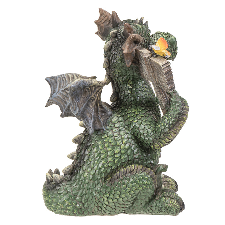 Dragon statue holding a 'Welcome' sign on a white background. Dragon is green with brown accents, yellow butterfly on the sign. Shown from the side