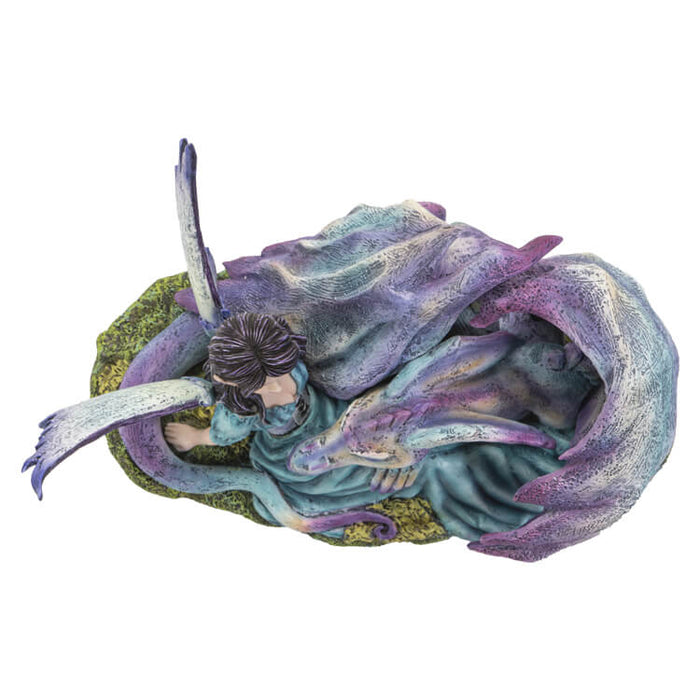 Figurine of a dragon with purple and blue napping on a fairy in a teal dress with black-purple hair. Top down view