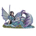 Figurine of a dragon with purple and blue napping on a fairy in a teal dress with black-purple hair