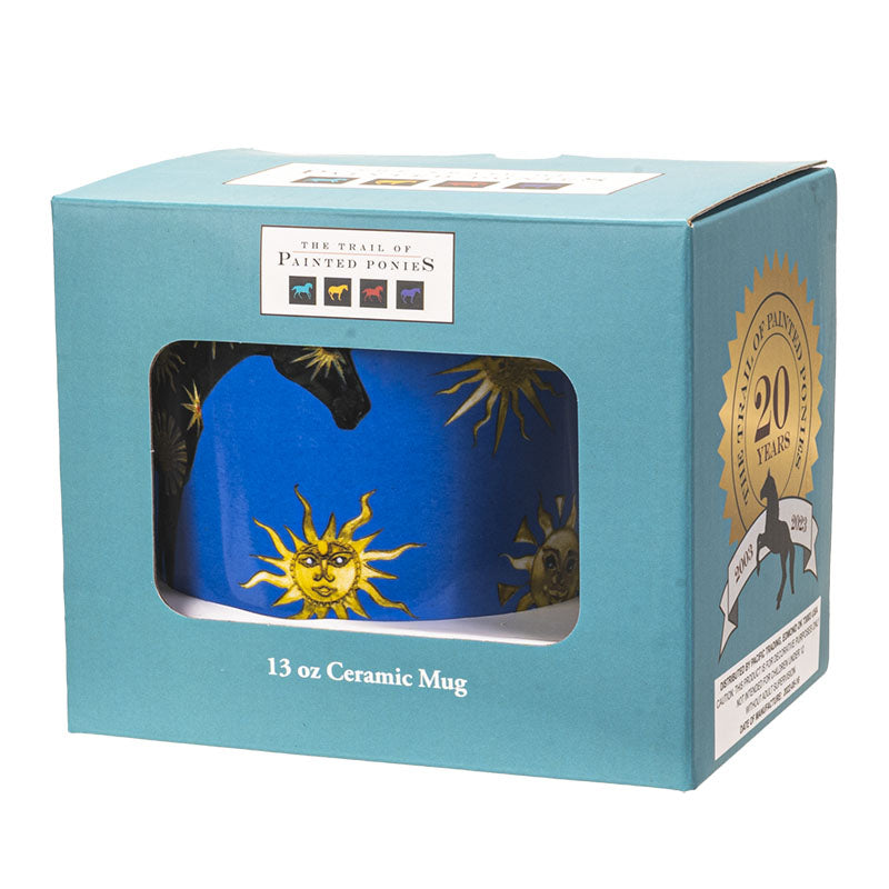 A blue ceramic mug featuring a black horse decorated with gold sun & moon motifs - shown boxed