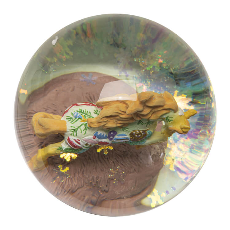 Snowglobe with festive ornament holiday pony inside and iridescent snowflake glitter. Base has holiday ornaments