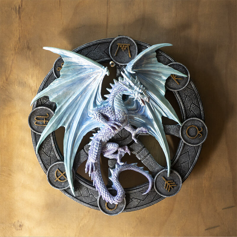 Icy blue silver dragon representing Yule on a black wheel with gold symbols