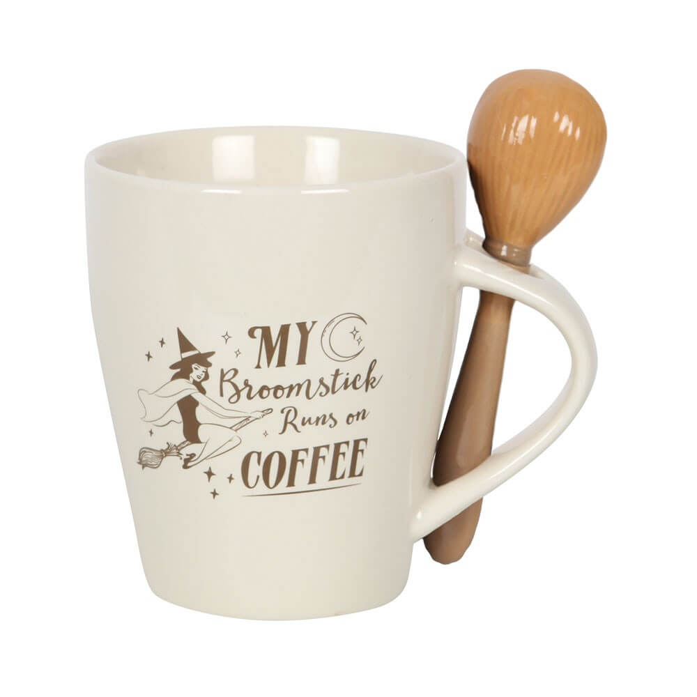 Mug and spoon set with cream colored mug and text "My Broomstick Runs On Coffee" with witch and moon art. Accompanying spoon looks like a broom