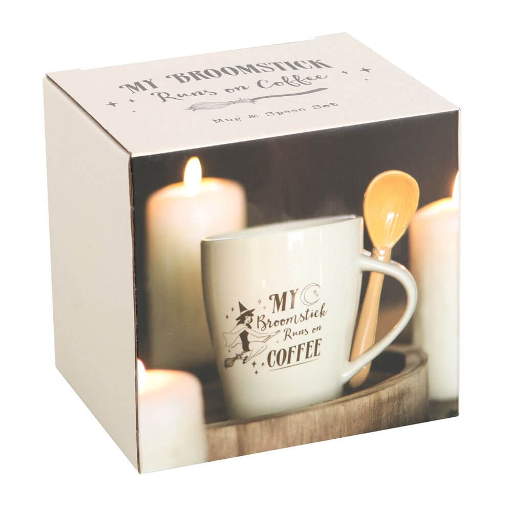 Mug and spoon set with cream colored mug and text "My Broomstick Runs On Coffee" with witch and moon art. Accompanying spoon looks like a broom. Comes in gift box