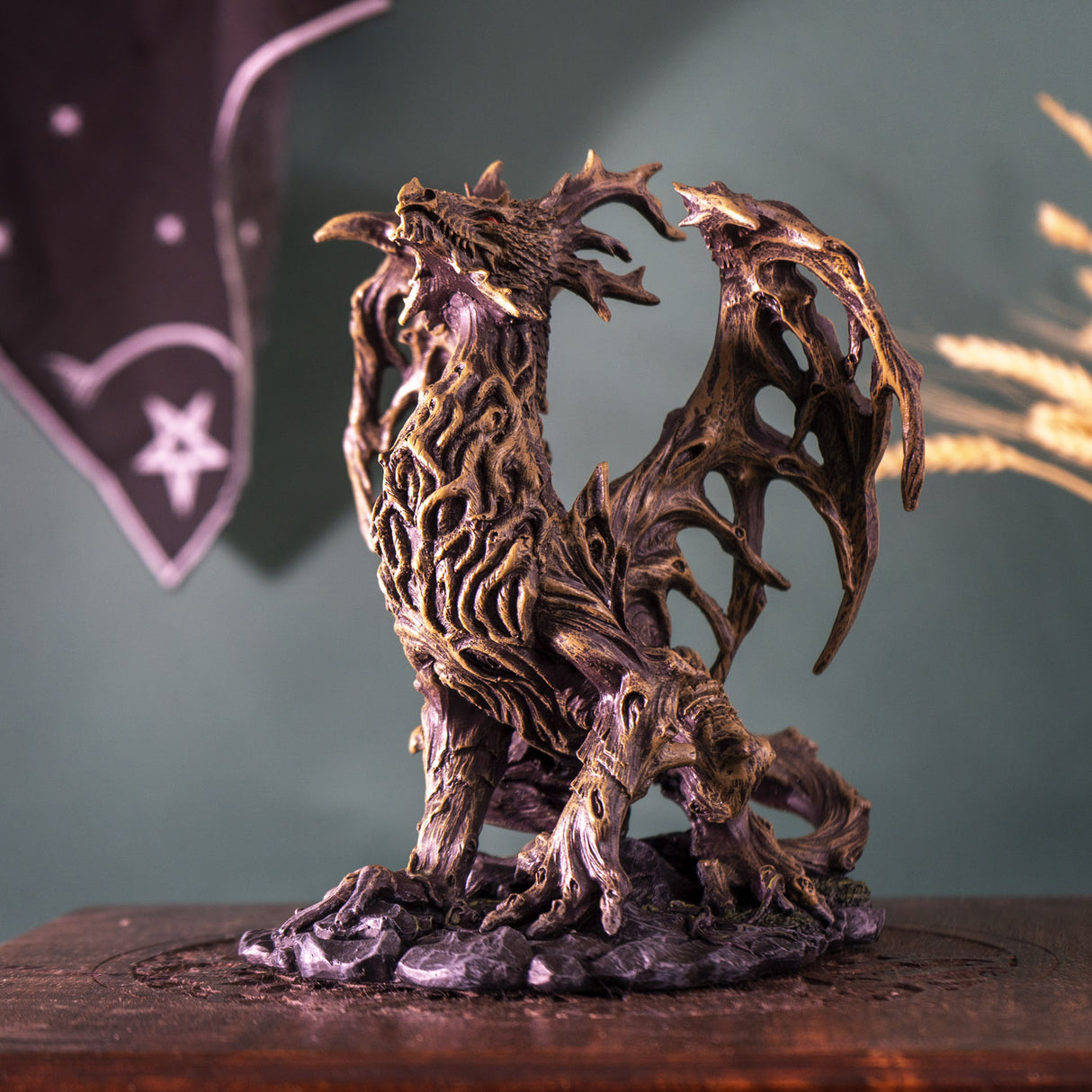 Figurine of brown dragon made up of branches, roots and tree trunks with red eyes