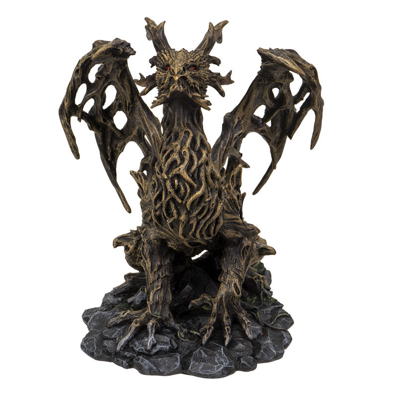 Figurine of brown dragon made up of branches, roots and tree trunks with red eyes