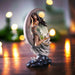 Fairy figurine based on Nene Thomas artwork, dark haired pixie perched on a silver crescent moon with a dove and blue clouds
