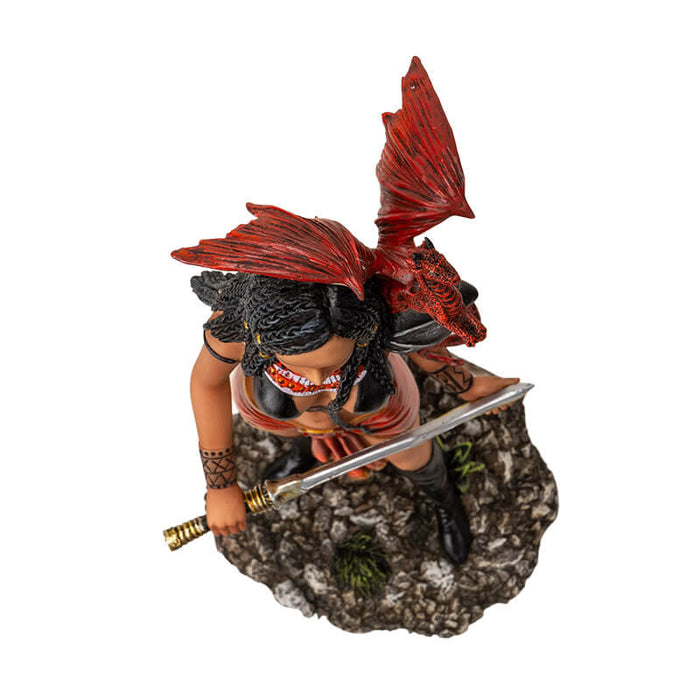 Figurine of a tanned skin woman with dark braided hair wearing black and red, holding a weapon with a ruby dragon on her shoulder. Shown top-down