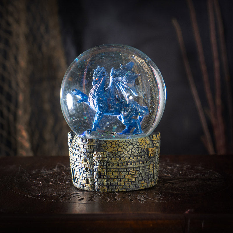 Snowglobe with blue dragon with red eyes within, castle base