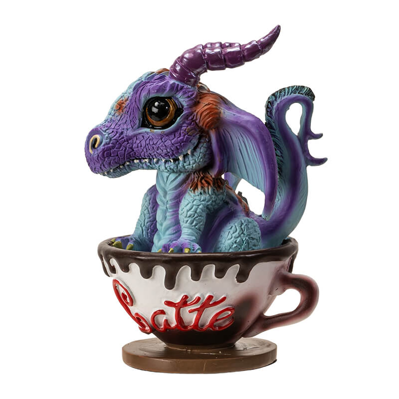 Figurine of a blue and purple dragon with big eyes sitting in a drippy cup labeled "Latte" in red