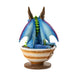 Figurine of blue, purple, green dragon with gold horns sitting in a cup of tea. Back view