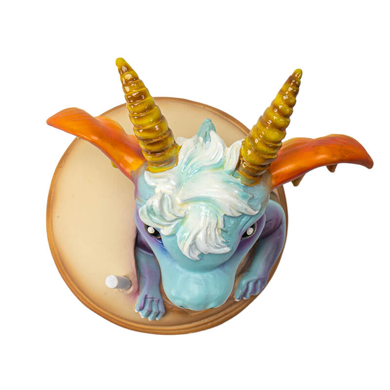 Figurine of blue dragon with red and gold accents sitting in Boba Tea (labeled in blue). Top down view