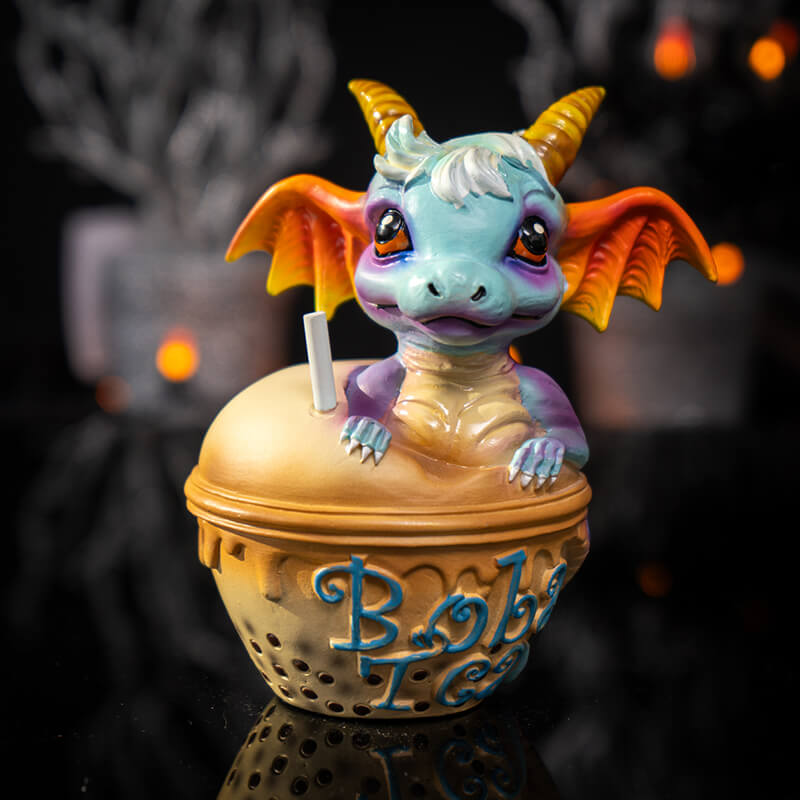 Figurine of blue dragon with red and gold accents sitting in Boba Tea (labeled in blue)