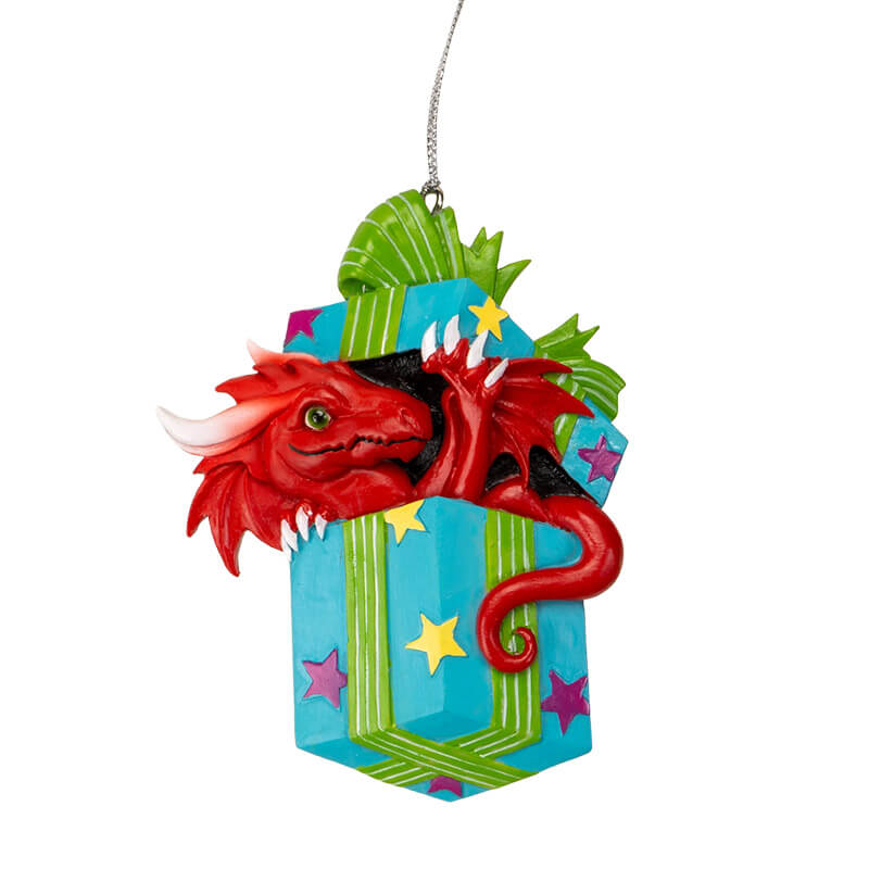 Ornament of red dragon popping out of a blue gift box with yellow and purple stars and green ribbon