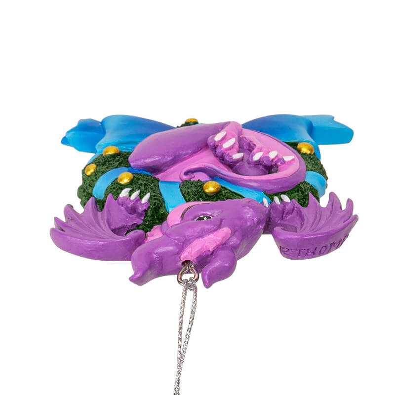 Ornament with purple and pink dragon in wreath with gold baubles and blue ribbon