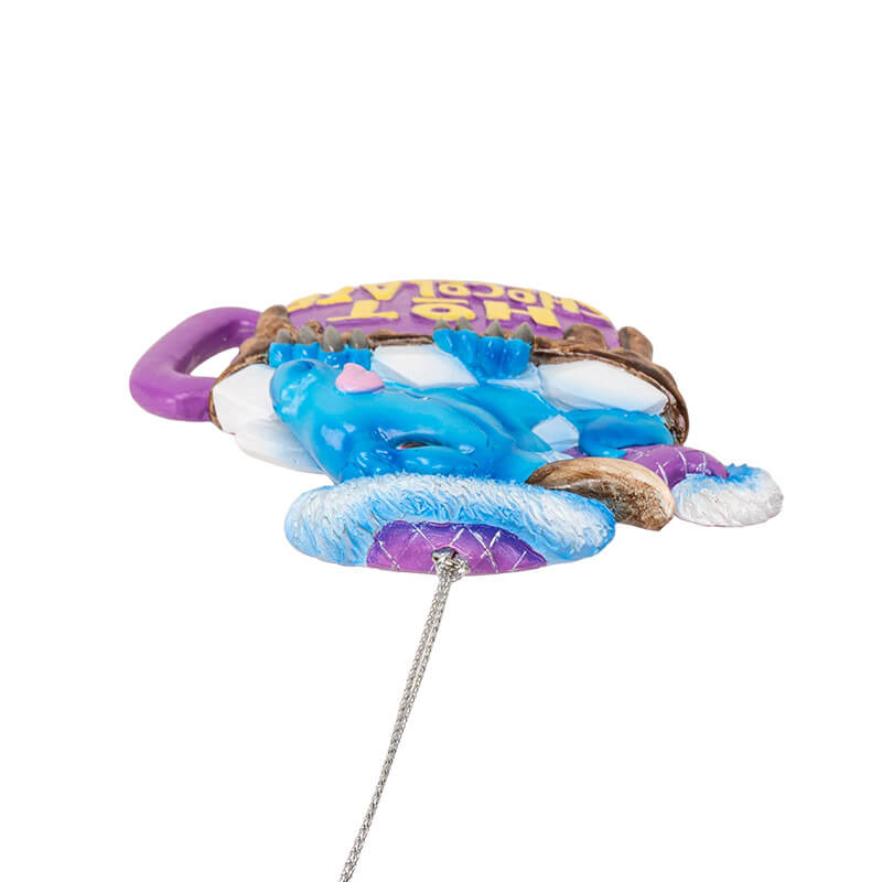 Ornament with blue dragon in purple hot chocolate mug with marshmallows and yellow lettering