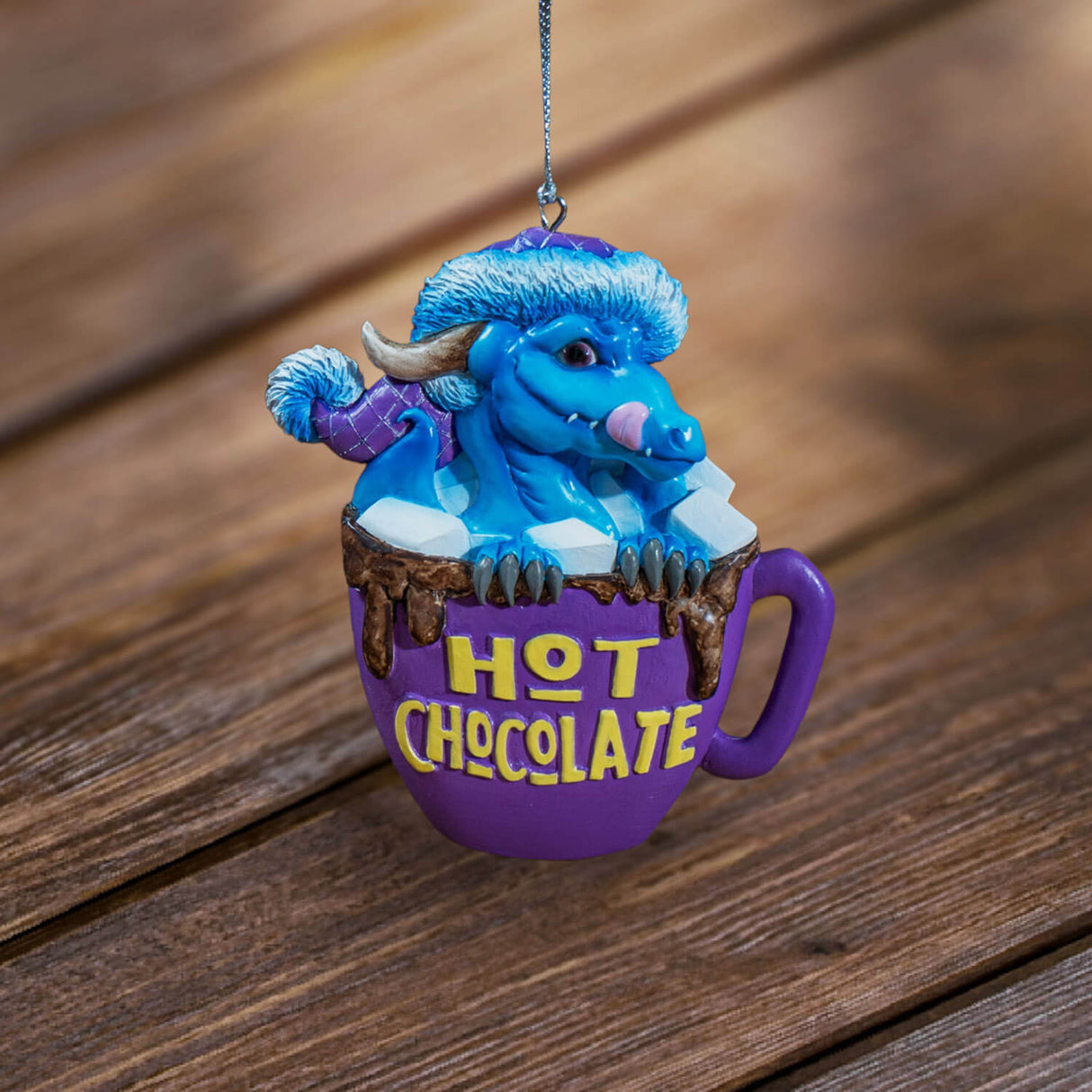 Ornament with blue dragon in purple hot chocolate mug with marshmallows and yellow lettering