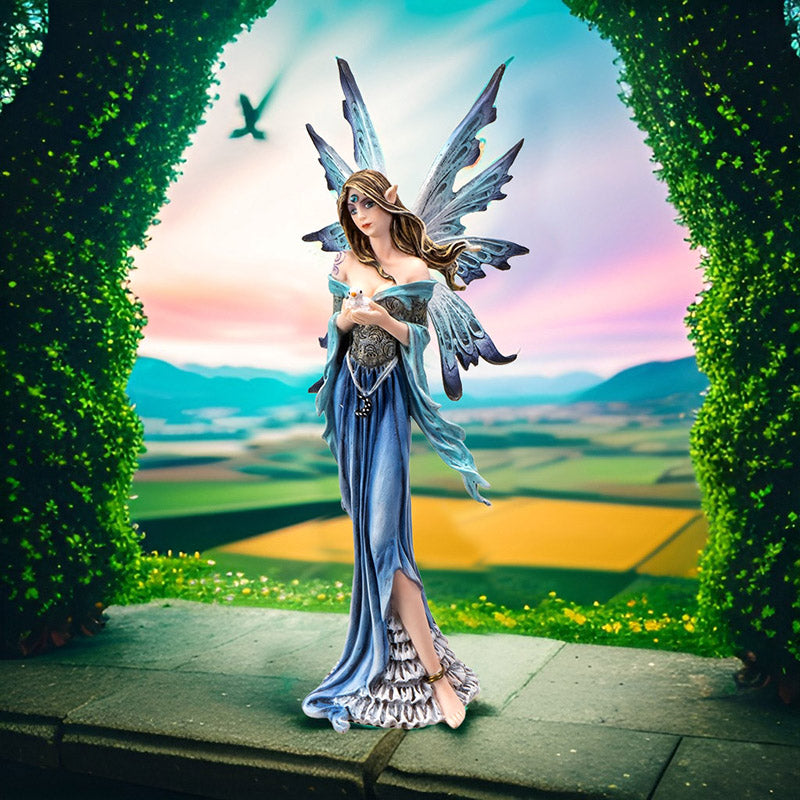 Fantasy fairy figurine with blue wings and dress holding a baby bird