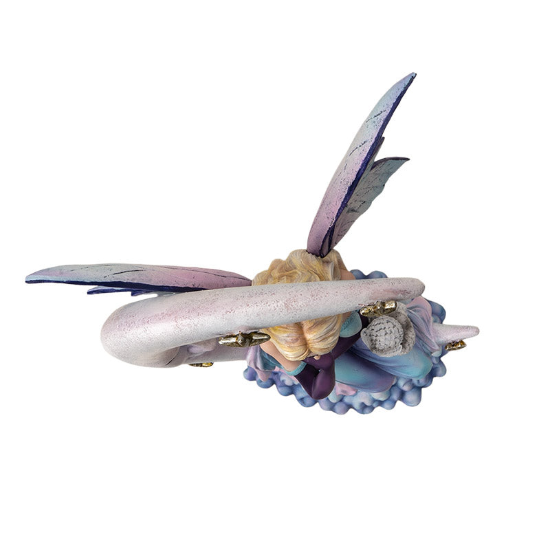 Fairy statue with a crescent moon and owl. Fairy has blue-purple-pink dress and blond hair, shown top down