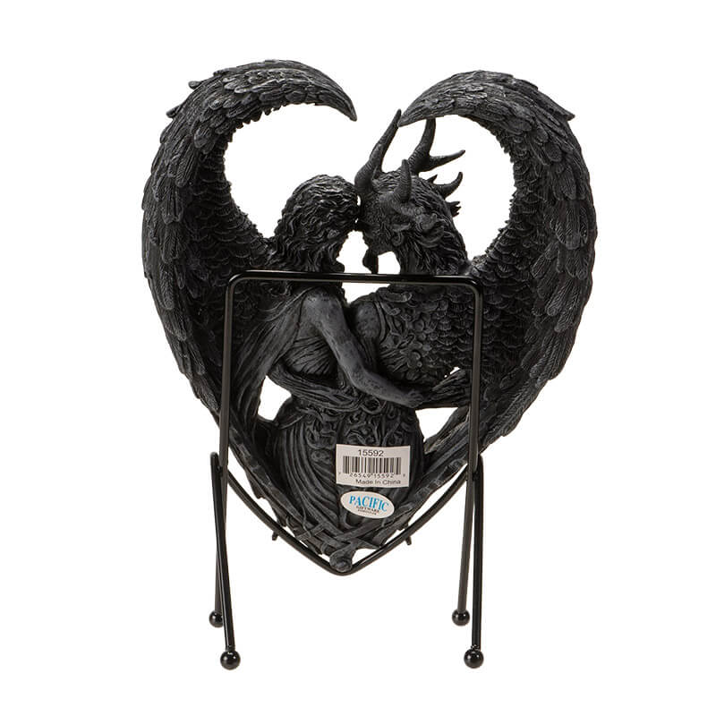 Figurine on stand of demon and angel forming a heart with their wings, done in faux-stone. Shown from the back