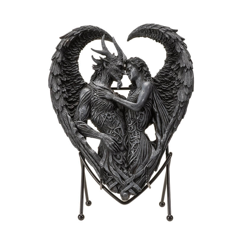 Figurine on stand of demon and angel forming a heart with their wings, done in faux-stone.