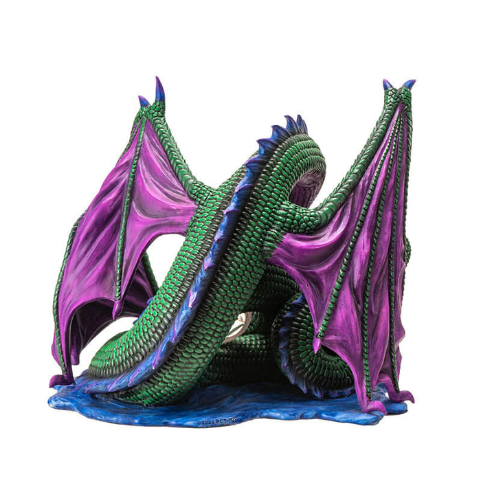 Figurine of green dragon with purple wings and blue spines on a water base with a rune at the center of its coils. View from the back