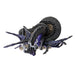 Figurine of a spider-dragon with purple and black scales and wings and eight eyes. Clutches crystals and sits on more gems. Top down view