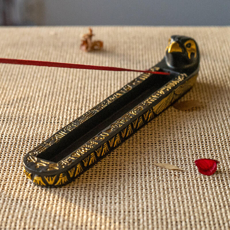 Incense burner with falcon headed Egyptian god Horus, black and gold with hieroglyphs