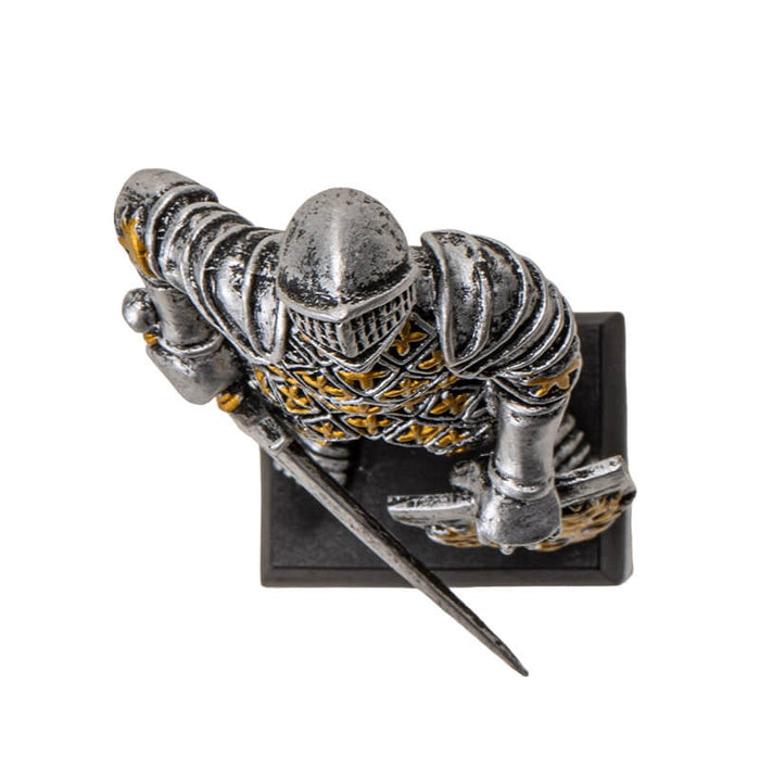 Figurine of knight in silver and gold armor with sword and lion rampant shield