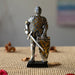 Figurine of knight in silver and gold armor with sword and lion rampant shield