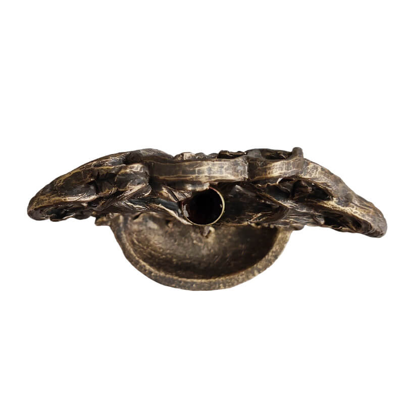 Tree of Life backflow cone incense burner with greenman face in faux-bronze. Shown top down with spot for incense cone