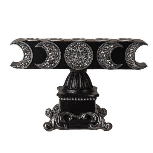 Candle holder with space for five candles. Silver moons and pentagram on black base.