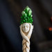Magic wand with faux-wood staff, face and braid, topped with green crystal cluster