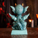 Cyan blue dragon figurine with flame sitting on a base that reads "You can never have too many dragons!" Shown from the back