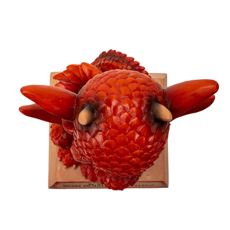 Figurine of a red dragon on a tan base that reads "W.W.A.D.D.? What Would A Dragon Do?" Top down view