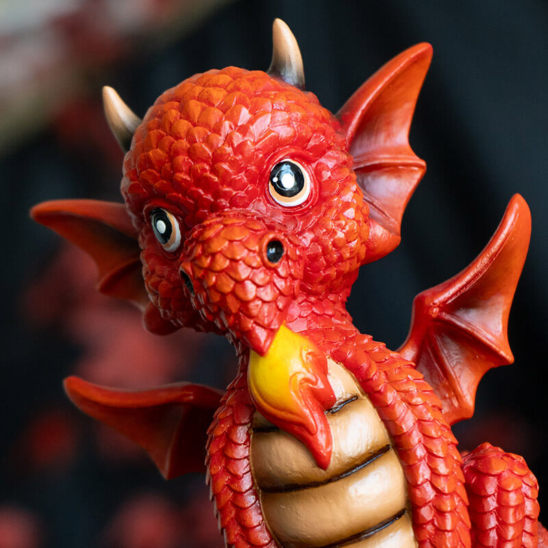 Figurine of a red dragon on a tan base that reads "W.W.A.D.D.? What Would A Dragon Do?"
